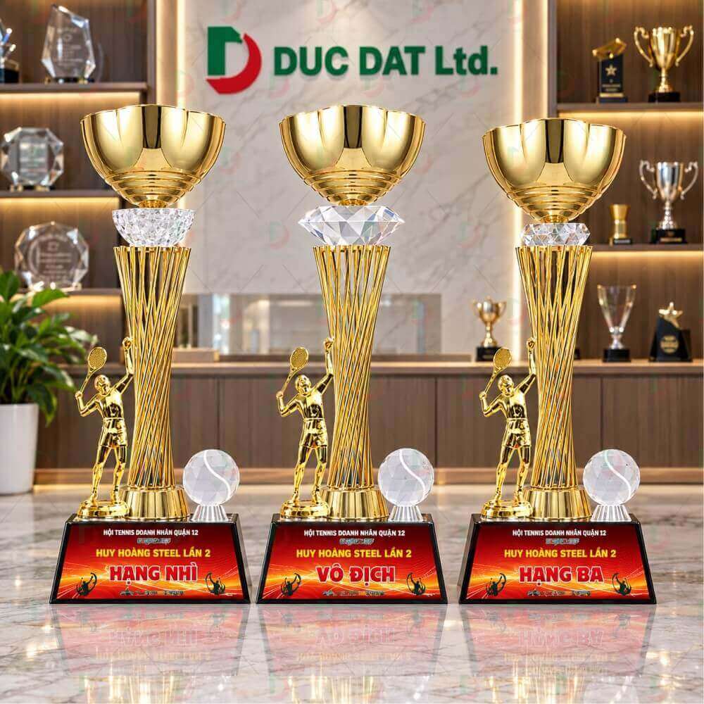 Cúp Tennis 84 thân kim loại, chén cúp lớn bằng kim loại và đế gỗ gắn mạc in nội dung.